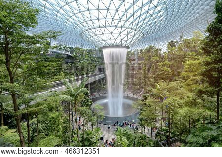 Changi, Singapore - 26/12/2022 : Jewel Changi Airport , Artificial Waterfall Dome With Plants Where