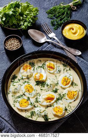 Senfeier,  Hard Boiled Eggs In Rich Creamy Mustard Sauce In Black Bowl On Concrete Table, German Cui