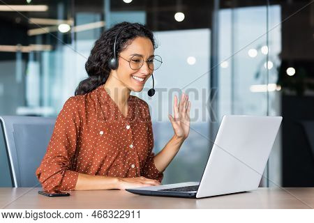 Happy Hispanic Woman Working Inside Office, Businesswoman With Video Call Headset Talking And Advisi