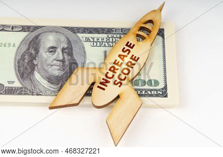 Business Concept. On The Dollars Lies A Wooden Model Of A Rocket With The Inscription - Increase Sco
