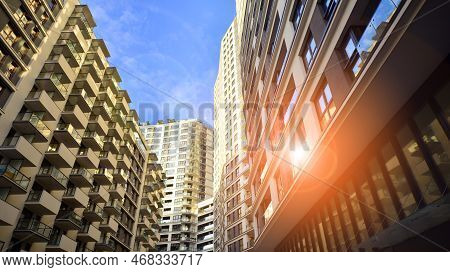The Narrow Passage Between Modern Residential Buildings. Walls Of High-rise Apartment Buildings And 