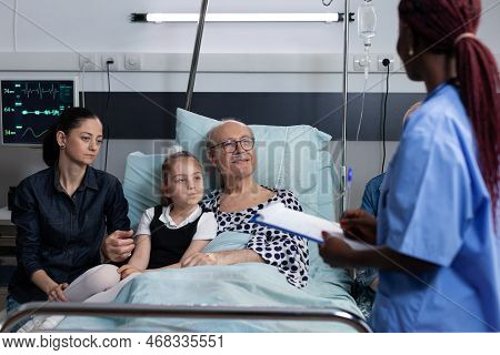 Grandfather, Close Relatives Receiving Report Of Old Man Surgery. African American Medical Student A
