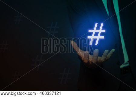 Hashtag Concept. Man Holding Sign On Dark Background, Closeup With Space For Text