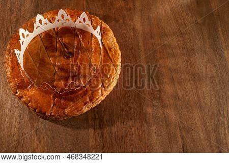 King Cake Or Galette Des Rois In French. Epiphany Pie With Golden Paper Crown