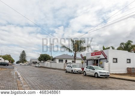 Bredasdorp, South Africa - Sep 23, 2022: A Street Scene, With A Signage Business And Houses, In Bred
