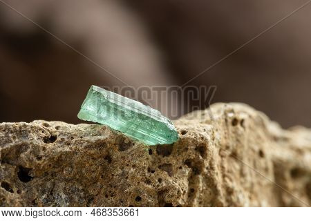 Raw Blue Tourmaline Crystal On Rough Stone Background In Natural Light