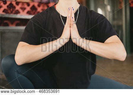 Close-up Photo Of The Torso Of A Female Yogi Doing A Skandasana Or Side Lunge Pose With Hands To Pra