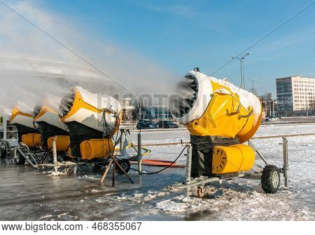 Four Snow Cannons Spray Artificial Snow Crystals. Production Of Artificial Snow. Snow Guns. Cars Mak
