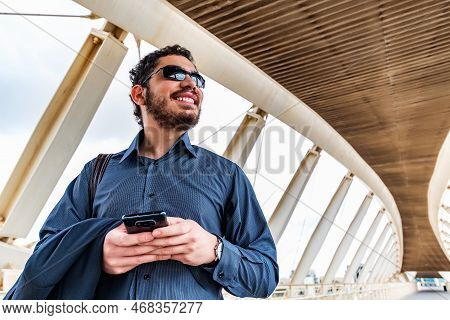 Businessman With Smart Phone, Standing At Bridge.