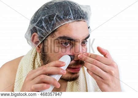 Young Caucasian Man Doing Facial Cleansing, Removing Pores Or Black Heads On Nose