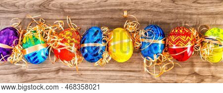 Easter Banner Background With Easter Eggs On Wooden Table. Top View.