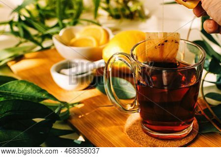 Natural Herbal Remedy For Cold And Flu. Composition With Tea And Warm Plaid On Wooden Table.