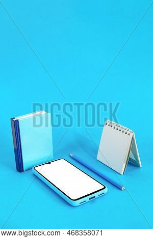 Book, Pencil, Notebook And Smart Phone On Blue Background. Education Concept. Digital Online Educati