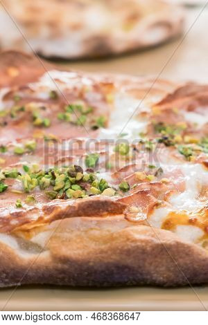Italian Pizza Close-up. Close Up Of Italian Pizza On Cutting Board. Various Pizzas In The Shop Windo