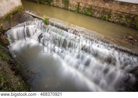 Long Exposure Of A Watefall On The River Lim Walkway At Lyme Regis In Dorset.