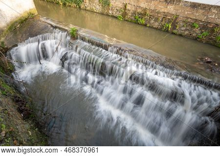 Long Exposure Of A Watefall On The River Lim Walkway At Lyme Regis In Dorset.