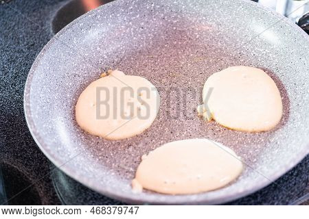 Frying Small Pancakes On A Kefir Base In A Frying Pan.