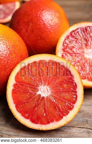 Whole And Cut Red Oranges On Wooden Table, Closeup
