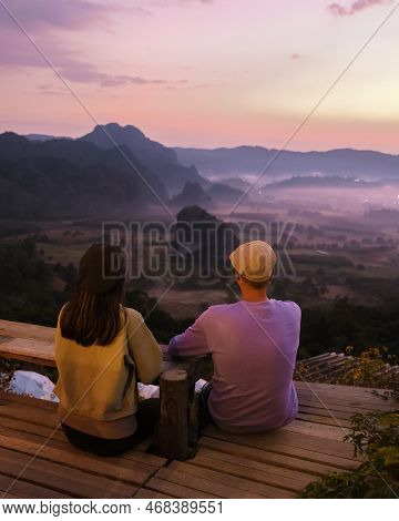 A Couple Watching The Sunrise With Fog At Phu Langka In Northern Thailand, Phu Langka National Park