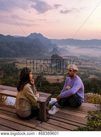 Couple Watching The Sunrise With Fog At Phu Langka In Northern Thailand, Phu Langka National Park