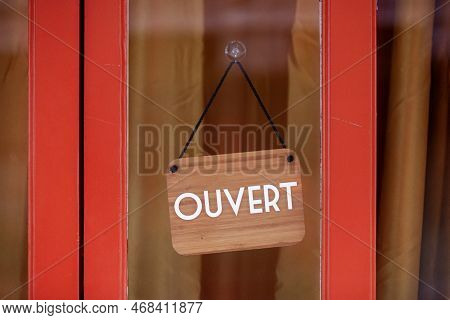 Sign At The Entrance Of A Restaurant Saying In French - Ouvert - Meaning In English - Open -.