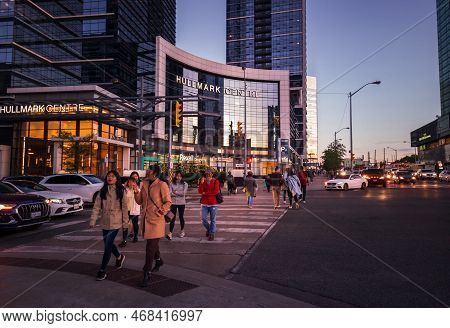 Toronto, Ontario, Canada - 09 23 2022: Pedestrians Walking On A Crosswalk At The Intersection Of You