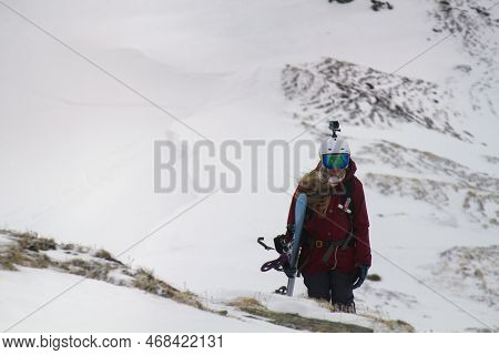 Kaltenbach ​hochfugen, Austria - 11 Jan, 2020: Snowboarder Female Climbs Mountains With Camera And A