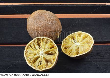 Dried Out Inedible And Rotten Oranges Spoiled From Improper And Lengthy Storage In Wooden Box On Ora