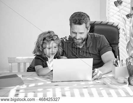 Homeschooling And Estudy. Back To School. Father And Son Use Computer At Home.