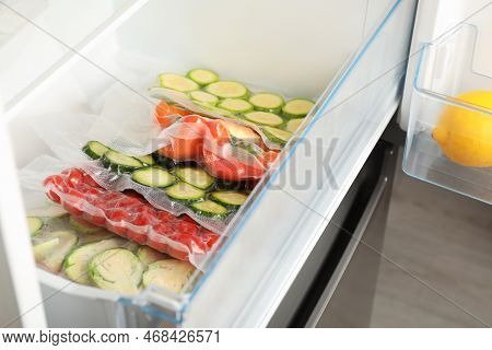Vacuum Bags With Different Vegetables In Fridge. Food Storage