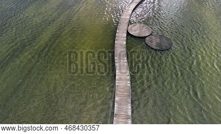 Floating Walkway Made Of Wooden Planks. Narrow Curved Paths On Stilts Driven Into The Bottom, Above 