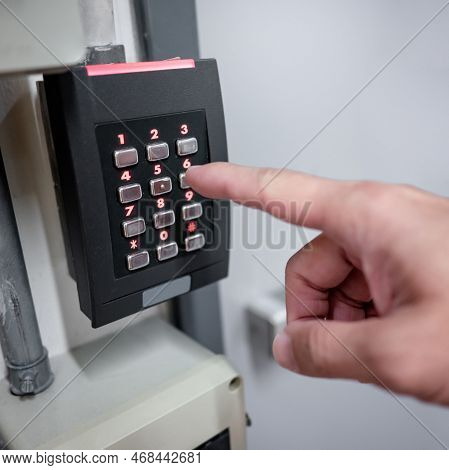Male Finger Entering Password Code Number On Numeric Keypad Of Smart Electronic Digital Door Lock On