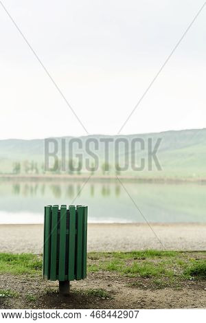 Green Trash Can On The Shore Of The Lake Lisi Park In Tbilisi, Georgia