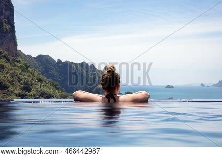 Woman Resting In Infinity Pool At A Aonang Beach Resort