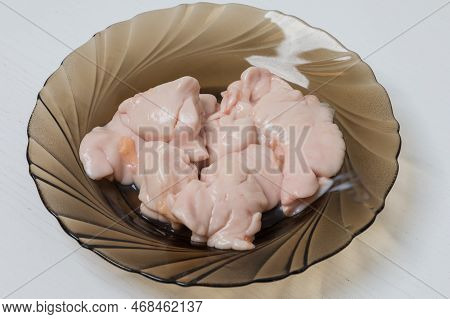 Raw Meat - Entrails - Carp Milk On A Plate.