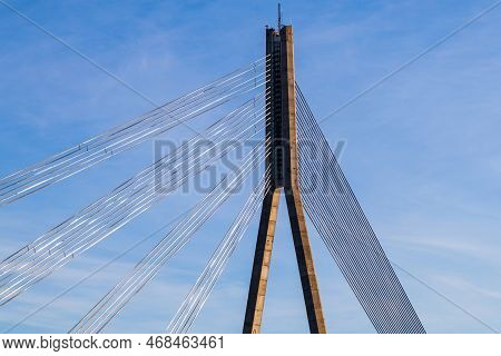 Central Support Of Cable-stayed Bridge With Anchoring Cables On Blue Sky Background.