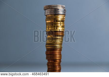 A Tall Stack Of Coins. Euro Coins Are Piled Up, The Largest Coins Are On Top Of The Smaller Ones.