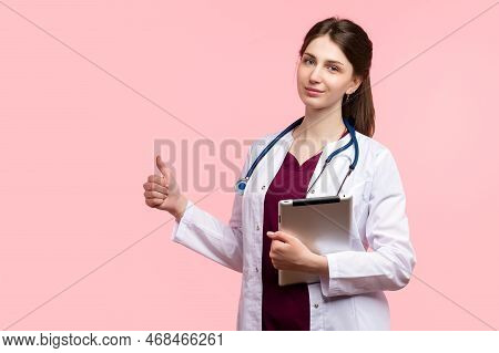 Woman Physician General Practitioner Shows Thumb Up Ok Gesture.  Medical Employee Practitioner Holds