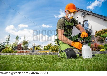 Professional Gardener Wearing Full Face Mask And Safety Glasses Getting Ready To Apply Pesticides On