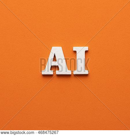 In White Letters The Acronym Ai Of Artificial Intelligence - Orange Foamy Background