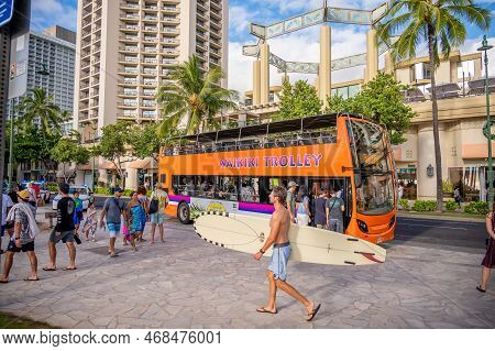 Honolulu, Hawaii - December 29, 2022: The Waikiki Trolley Picking Up Tourists On Kalakaua Avenue.