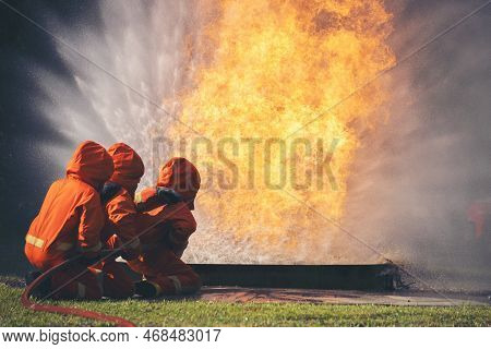 Firefighter Fighting With Fire Flame Protection Property. Fireman Wear Hard Hat, Body Safe Suit Unif