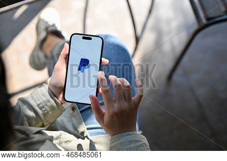 Chiang Mai, Thailand - Dec 27 2022: A Female Using Paypal Application On Her Smartphone, Transferrin
