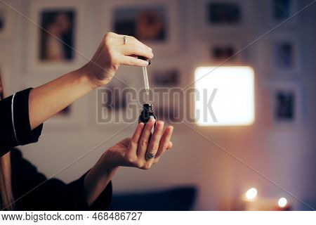 Woman Using A Vitamin C Serum For Skin Care Before Bedtime