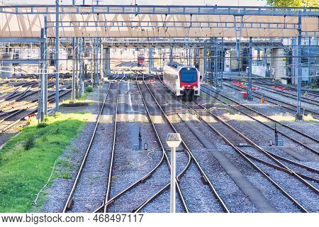 Geneva, Switzerland - 08 September 2022: Swiss Modern Trains In Red And White Are Parked Near A Rail