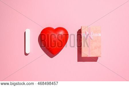 Congratulations On Valentine's Day And On March 8. Red Heart And A Gift On A Pink Background.