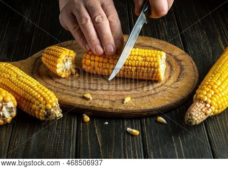 The Cook Cuts The Maize With A Knife. Corn Is An Excellent Dietary Breakfast Or Lunch. Working Envir