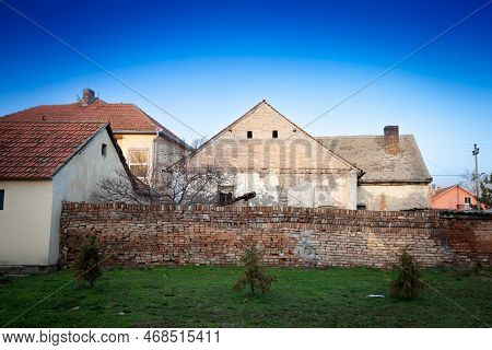 Old Walls And A Crumbling Facade On An Abandoned Residential Building Of A Farm In Ruma, Vojvodina, 
