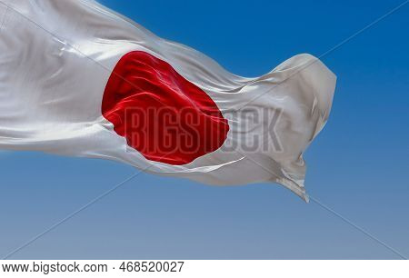 Japan National Flag Waving In The Wind On A Clear Day. Red Disc On A White Field. Japan Is An Island