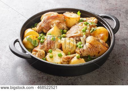 Chicken Pieces With Potato Wedges And Roasted In A Lemon Garlic White Wine Sauce Close-up In A Fryin